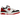 New Balance 550 White Red Black sneakers i profil, der viser hvid læderoverdel, røde detaljer ved kraven og en sort sål samt logo