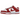 Nike Dunk Low USC sneakers i en vinklet visning med hvid overdel, røde læderoverlejringer, rød swoosh og en matchende hvid og rød gummisål
