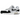Nike Air Max 1 White Black GS sneakers i vinklet profil med hvid overdel, sort mudguard, swoosh-logo og synlig Air-enhed i sålen.